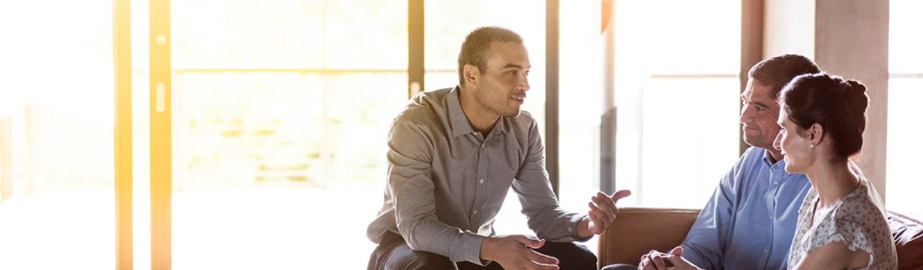 Young man sitting down for talk with his parents 